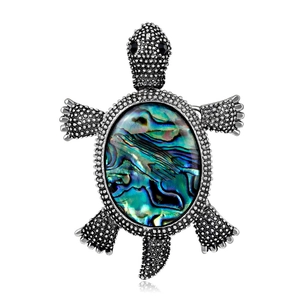Broche tortue vintage avec nacre d'abalone colorée et perles argentées élégantes
