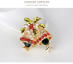 Detail of Christmas bell brooch featuring golden hollow design and sparkling rhinestones