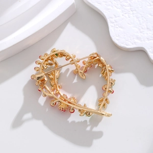 Golden heart brooch with mimosa fruit enamel pattern and secure back pin closure