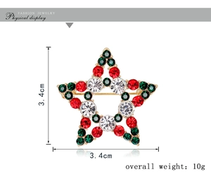 Détail d'une broche étoile de 3,4 cm avec strass rouges et verts sur base or