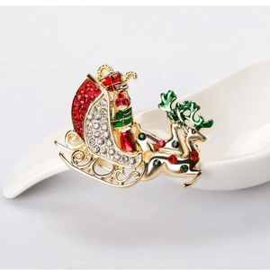 Christmas brooch with Santa on red sleigh and reindeer featuring vibrant rhinestones