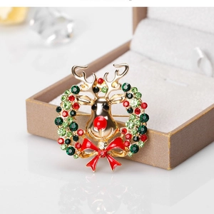 Christmas reindeer wreath brooch with red bow and colorful rhinestones in gold finish