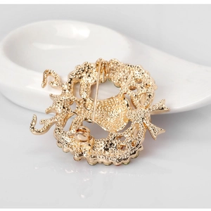 Golden reindeer Christmas brooch with bow detail shown from the back perspective