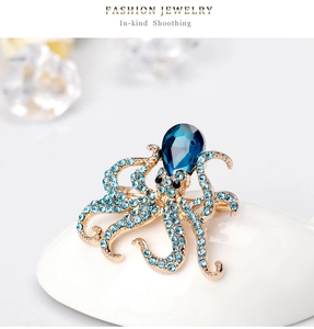 Macro shot of octopus brooch featuring blue pear-shaped stone and crystal pavé details