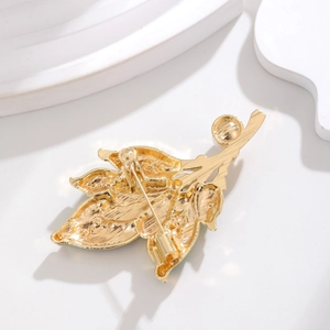 Back view of gold leaf brooch showing fine vein texture and secure pin clasp design