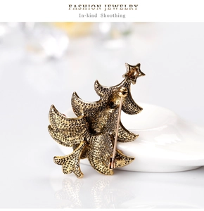 Macro shot of the Christmas tree brooch back with textured metal and secure safety pin