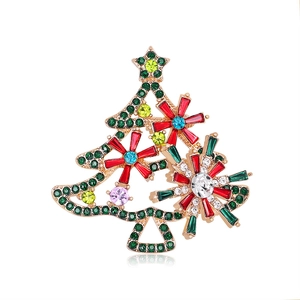 Elegant gold alloy Christmas tree brooch with colorful rhinestones on white background