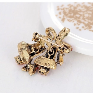 Vintage gold alloy Christmas bell brooch with red enamel details and bow design