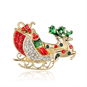 Golden Christmas sleigh brooch with reindeer and sparkling red and white rhinestones