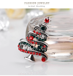 Macro shot of a vintage Christmas tree brooch with colorful rhinestones and silver finish