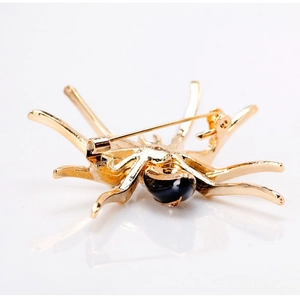 Retro spinbroche van goudkleurige legering met zwart kristal, detail van de achterspeld
