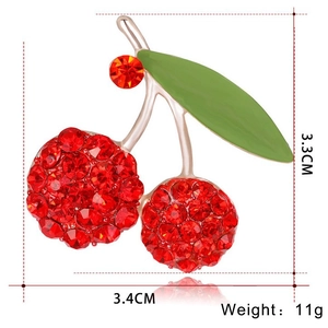 Exquisite red cherry brooch with sparkling rhinestones and green leaf in golden finish
