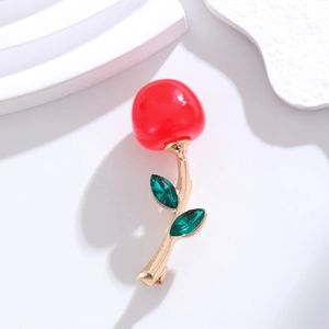 Elegant cherry brooch with red glossy fruits and green marquise gems on gold base