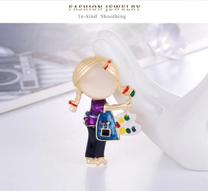 Detail of artistic girl painter brooch with colorful enamel palette on ceramic holder