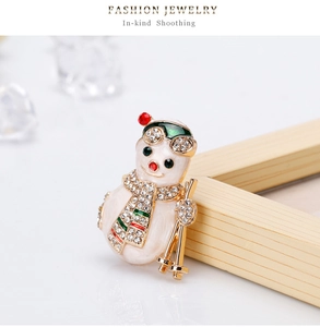 Détail d'une broche bonhomme de neige skieur avec strass et émail multicolore
