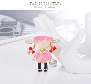 Artistic girl brooch with pink enamel, cat eye stone head and red bow detail