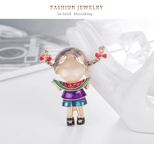 Detail of cartoon girl brooch with opal head and watermelon on a white display stand
