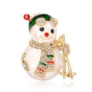 Broche de bonhomme de neige de Noël tendance en émail blanc et doré avec strass brillants