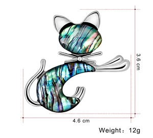 Detailed view of silver cat brooch with iridescent shell inlay measuring 4.6cm by 3.6cm