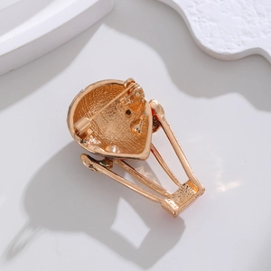 Back view of golden hot air balloon brooch featuring a secure rotating safety pin clasp