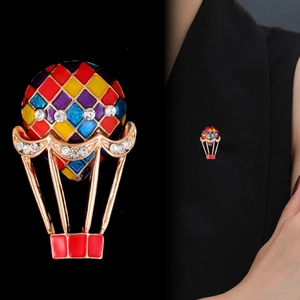 Macro view of colorful enamel hot air balloon brooch with rhinestones and wearing demo
