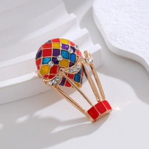 Colorful enamel hot air balloon brooch with sparkling rhinestones in a gold alloy frame