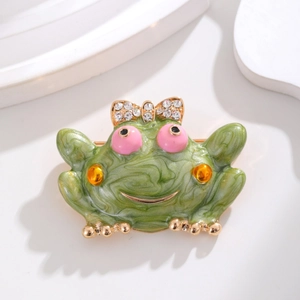 Exquisite frog shaped brooch with green enamel finish and crystal bow accent for suits