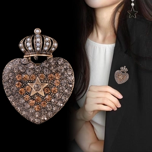 Vintage heart crown brooch with rhinestones and pearls shown on a black suit jacket