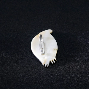 Elegant natural shell eye-shaped brooch with silver security pin on back view