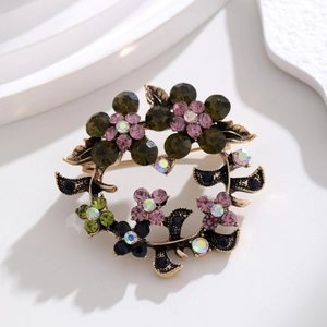 Vintage olive branch wreath brooch with colorful rhinestones in an antique gold setting