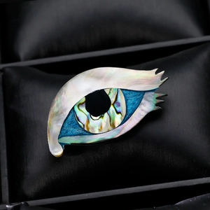Exotic eye-shaped brooch with natural shell and abalone inlay on black silk