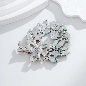 Silver alloy Christmas wreath brooch with green red enamel showing stable pin back structure