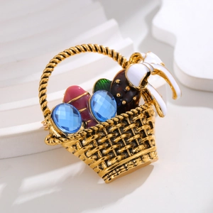 Vintage flower basket brooch with blue gemstones and a white ribbon on a white podium