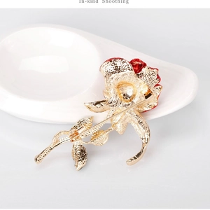 Handcrafted red rose brooch with golden metal backing and secure safety pin closure