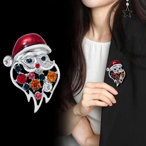 Sparkling Santa Claus brooch with red enamel and colorful rhinestones on a black suit
