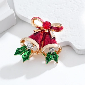 Spilla a campanella di Natale con fiocco rosso e strass scintillanti su gioielli festivi