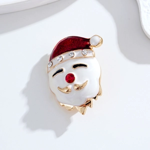 Cute mini Santa Claus brooch with red enamel hat and sparkling rhinestones on white tray