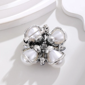 Vintage Baroque floral brooch with white pearls and antique silver finish on white stand