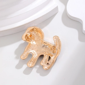 Back view of a gold puppy brooch showing the secure safety pin clasp and alloy texture