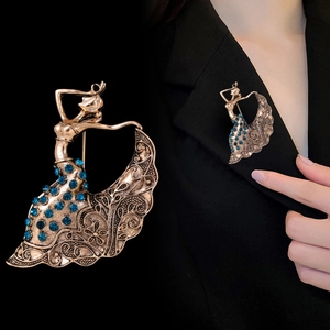 Detailed close-up of retro Goddess brooch with blue rhinestones on black blazer