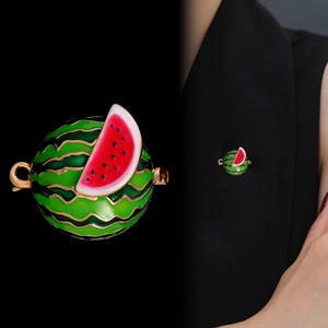 Detail of enameled watermelon brooch with glossy finish and lifestyle wearing shot on suit