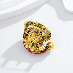 Back view of cute Christmas hat brooch in gold alloy with red rhinestones and secure pin