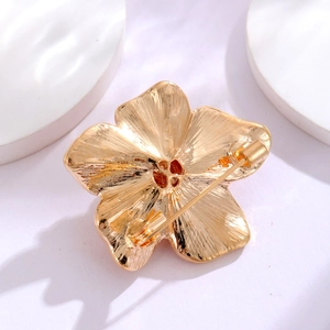 Back view of vintage camellia pearl brooch with golden metal brushed texture and pin clasp
