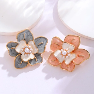Vintage camellia flower pins with enamel petals and central pearls for elegant suits