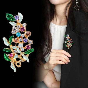 Elegant floral leaf brooch with colorful crystals and enamel finish on black background