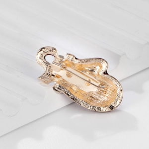 Back view of gold alloy Christmas glove brooch with secure safety pin on white stone