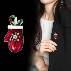 Detail of red Christmas glove brooch with snowflake and rhinestone on a suit lapel
