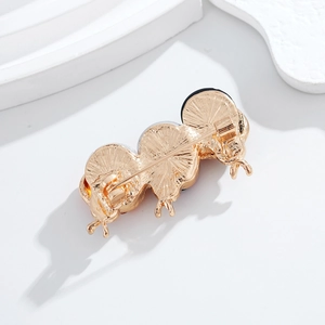 Spilla a coccinella color oro champagne con tre unità rotonde e trama a raggio di sole
