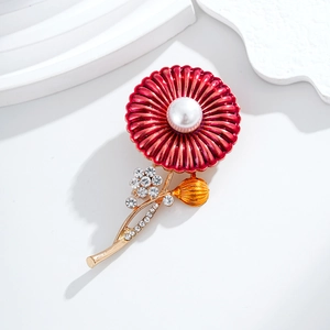 Elegant red enamel daisy brooch with pearl center and rhinestone accents on white pedestal