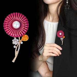 Elegant rose red daisy brooch with pearl center and rhinestones on black blazer